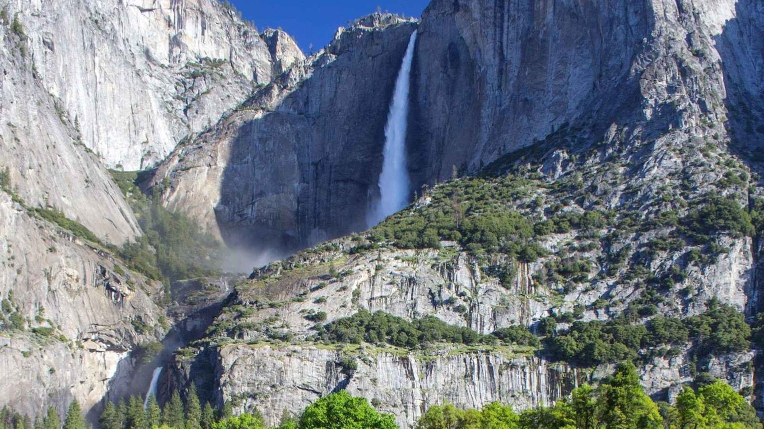 Waterfall in full flow down a rock face in Yosemite National Park.